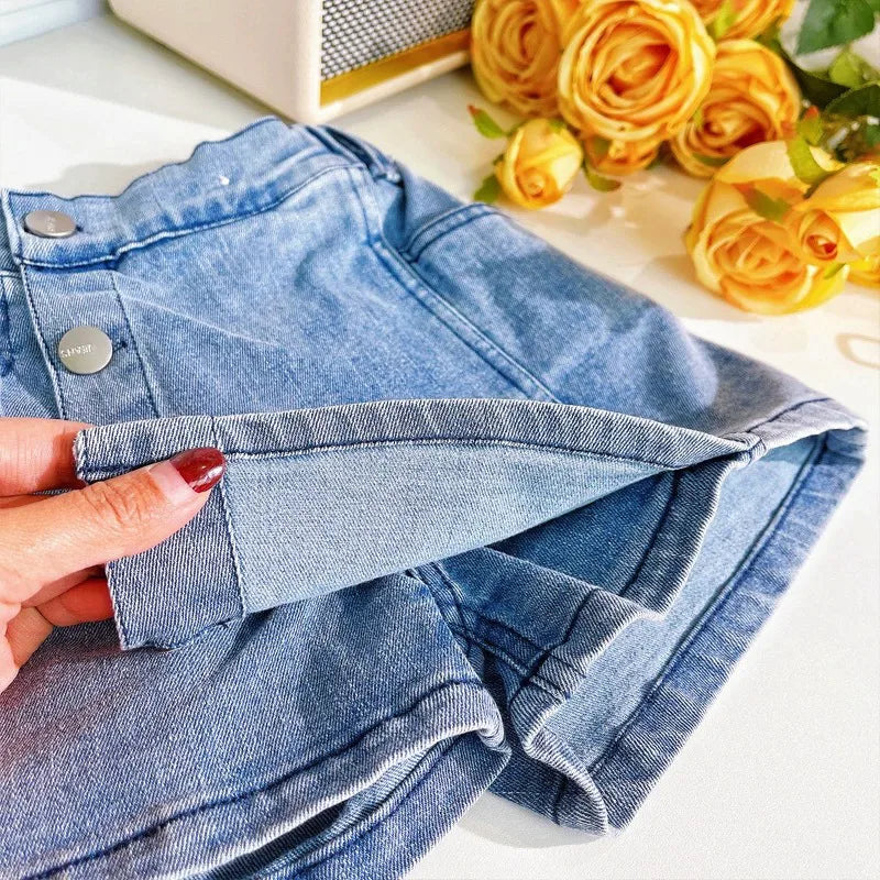 "Trendy A-line skort in denim with a structured silhouette and pockets."